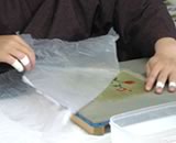carefully removing the shielding paper